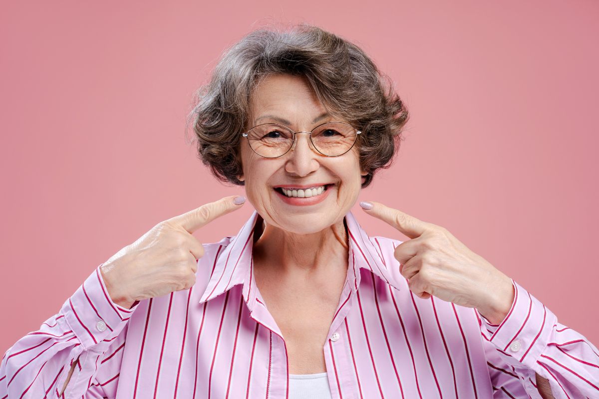 Patient smiling confidently after dental implant treatment.
