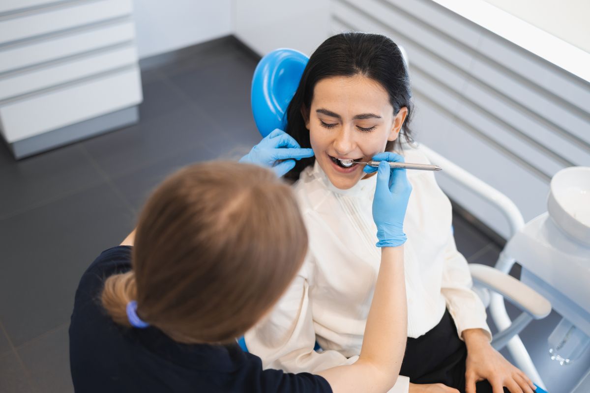 Dentist performing a routine dental checkup, promoting daily habits for healthy teeth and gums.